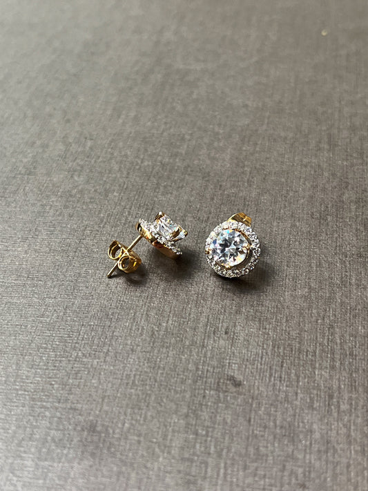 Side view of CZ stud earrings highlighting gold prongs and push-back posts