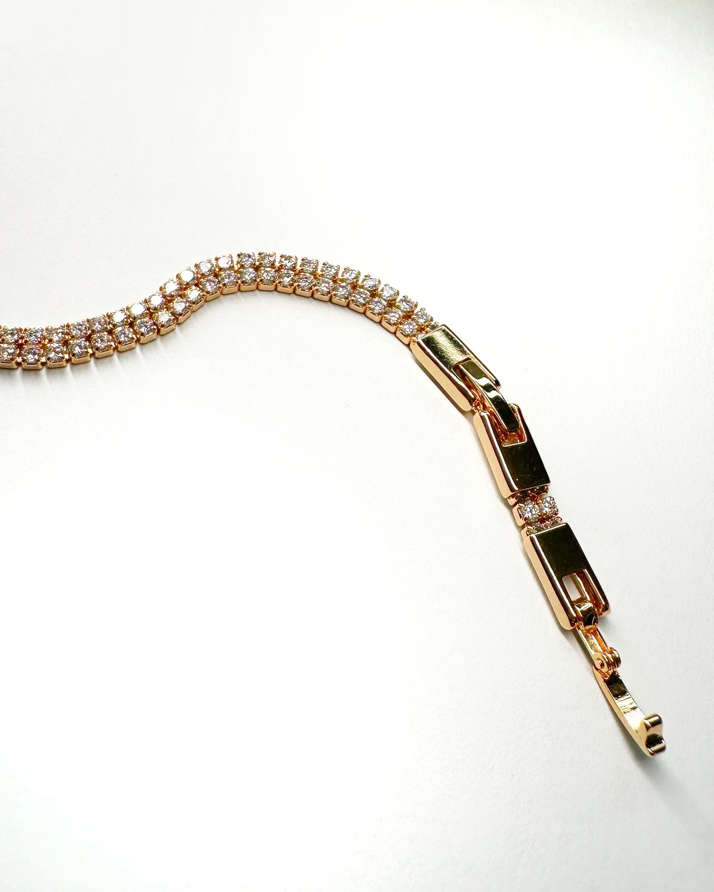 Flat lay of bracelet showing CZ sparkle and fold-over clasp