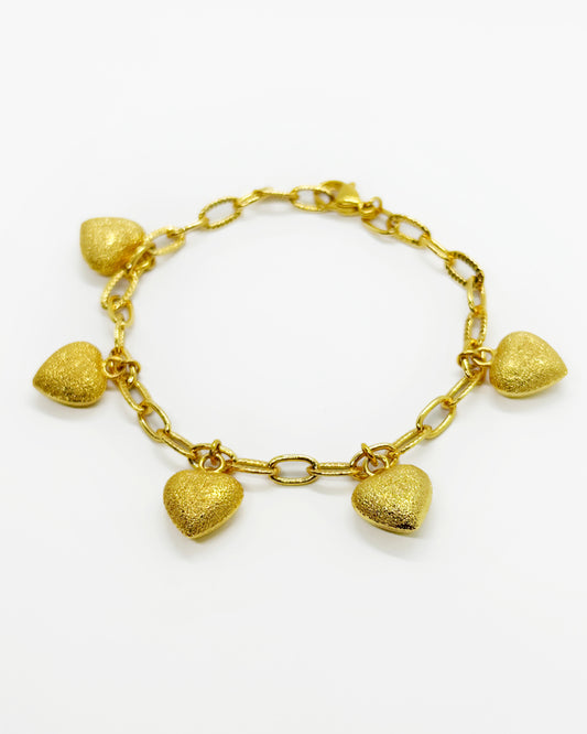 Gold link chain bracelet with frosted heart charms