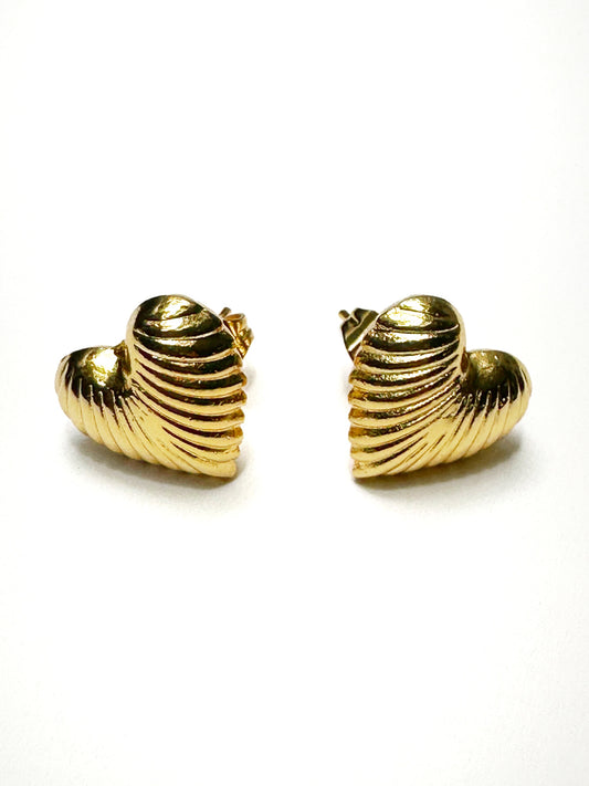 Front view of ribbed heart earrings laid side by side on white backdrop