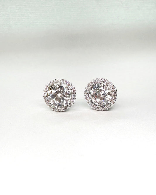 Front view of halo cubic zirconia stud earrings with brilliant round-cut center stones and pavé-set halo on a white backdrop