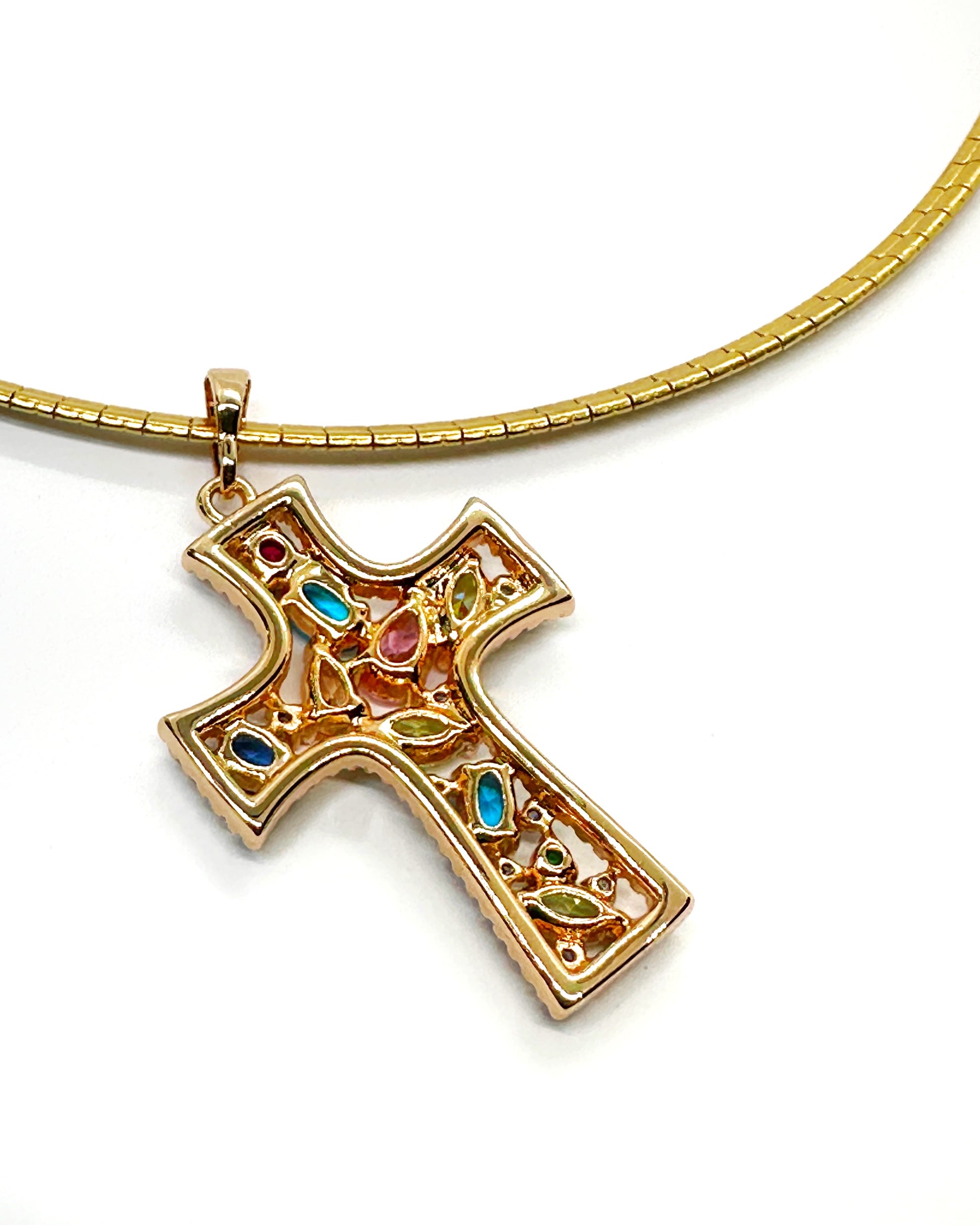 Back view of cross pendant showing gold finish and stone setting