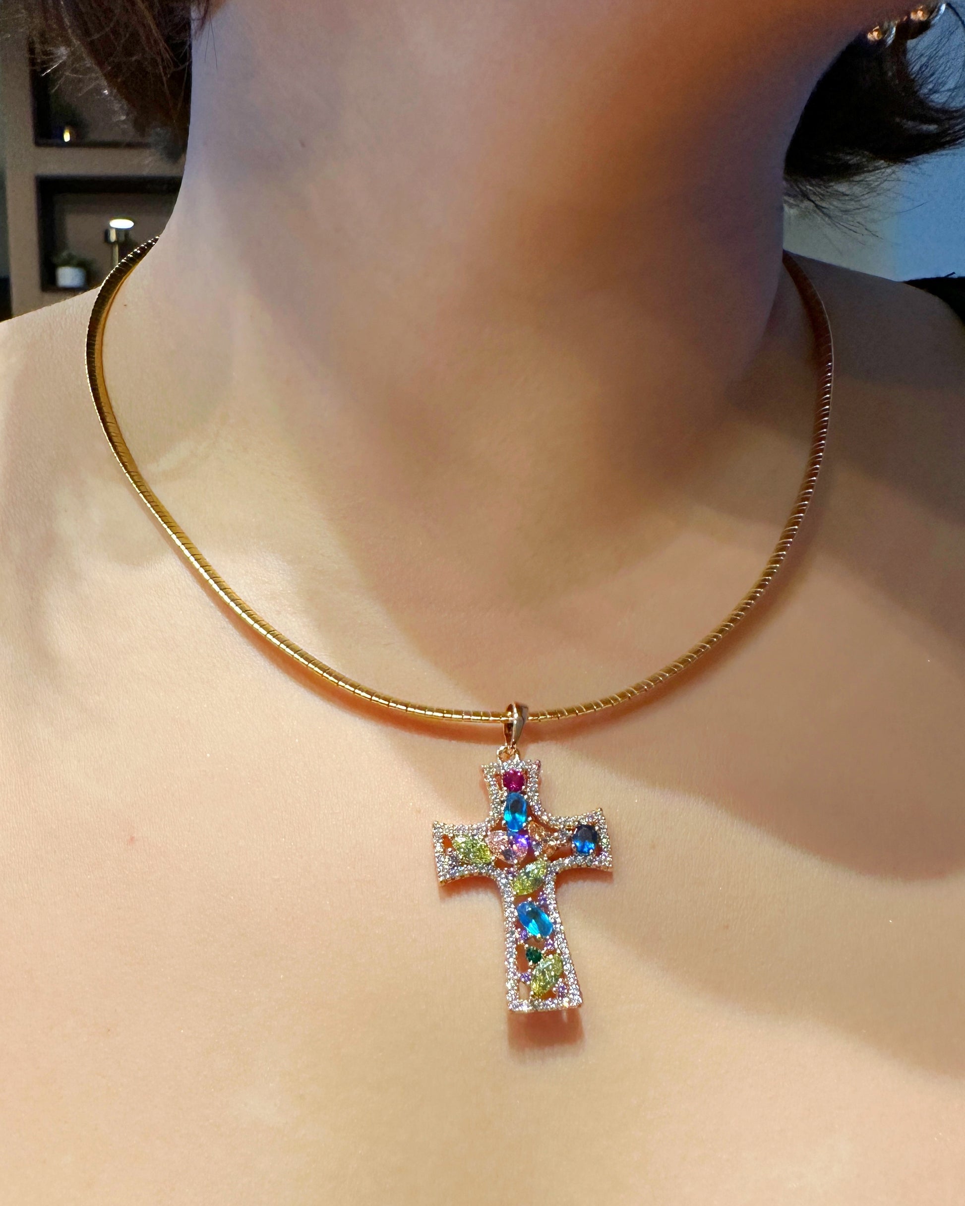 Model wearing 18K gold-plated cross necklace styled with clean neckline