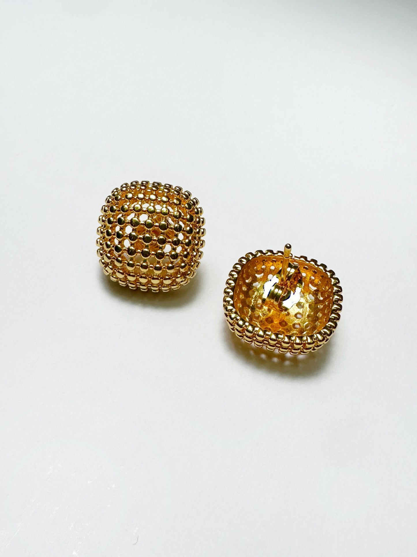 Inside view of stainless steel mesh earrings showing lightweight dome structure