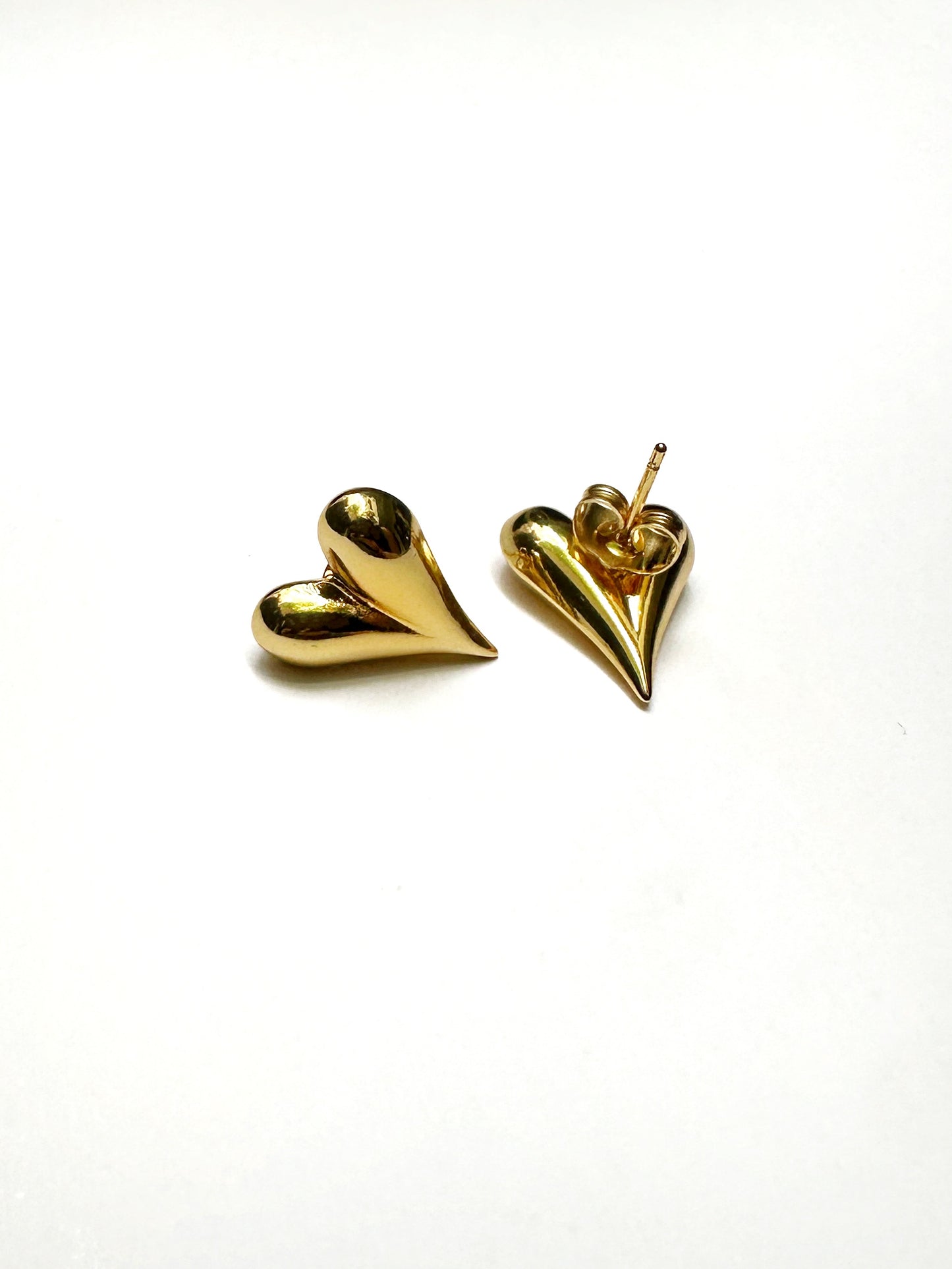 Close-up showing back post of gold stainless heart earrings