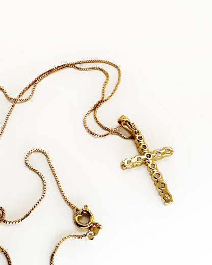Back view of gold cross pendant necklace showing stone setting