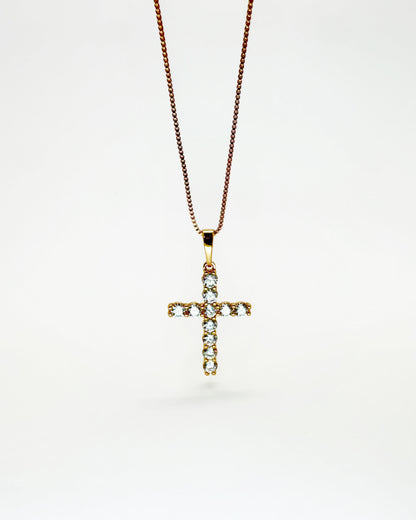 Gold zirconia cross pendant necklace on white background