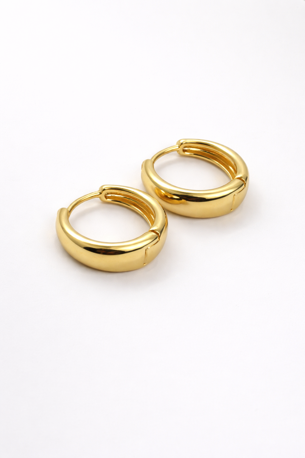The Cashew Huggie Hoop Earrings in Gold Tone