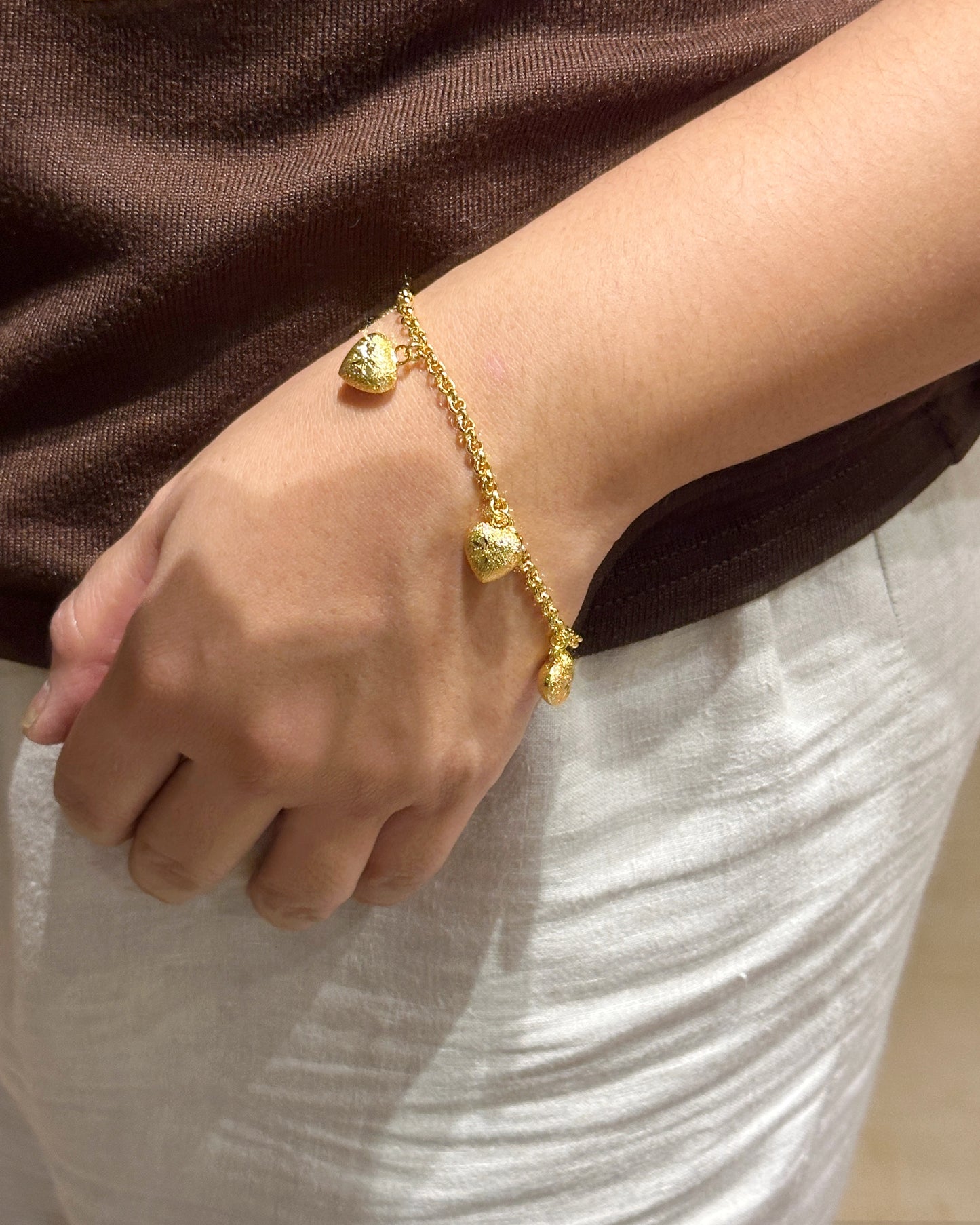 Frosted engraved heart charm chain bracelet worn on wrist for fit reference