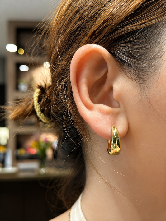The Cashew Huggie Hoop Earrings in Gold Tone