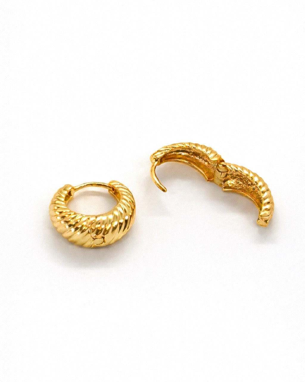 18K gold tone ribbed hoop huggie earrings showing hinged clasp and spiral shell design