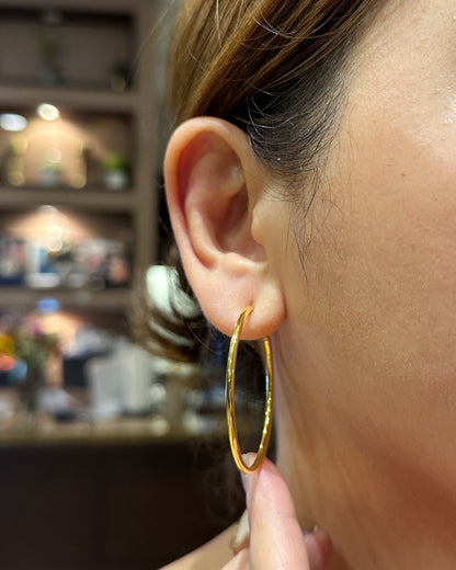 woman wearing 1.8 inch thin gold hoop earrings stainless steel everyday jewelry look