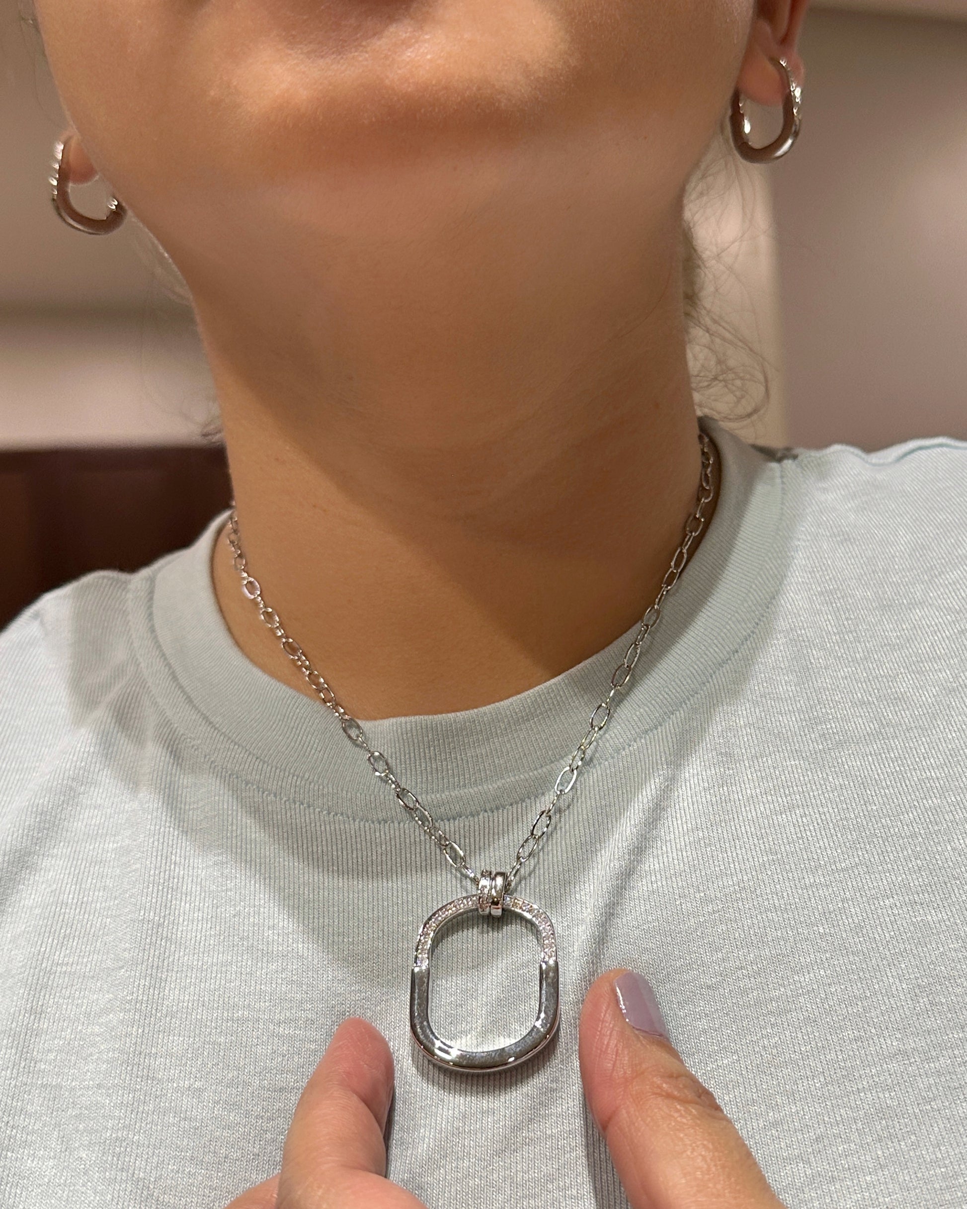 Model wearing oval link zirconia pendant necklace showing real-life size and fit
