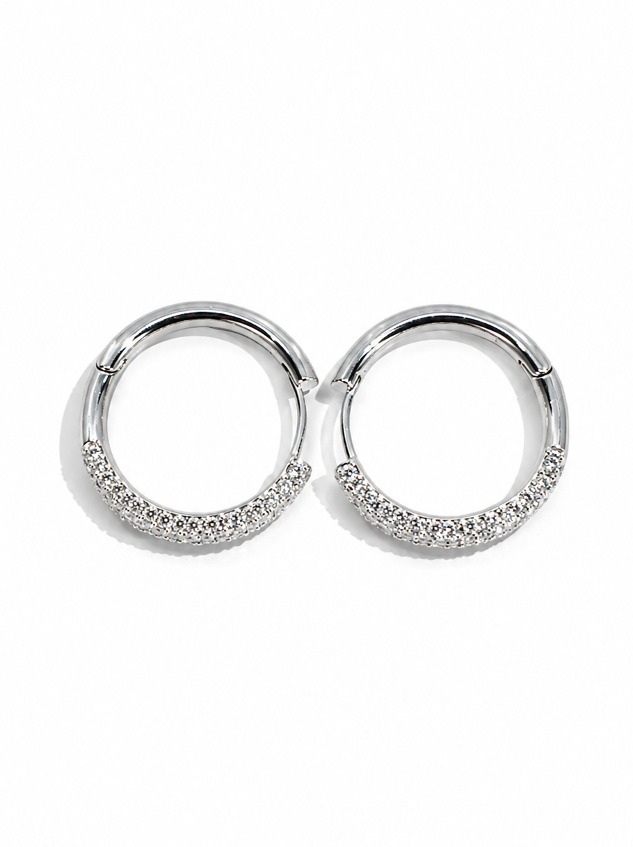 Pair of silver hoop earrings with small stones on a white background