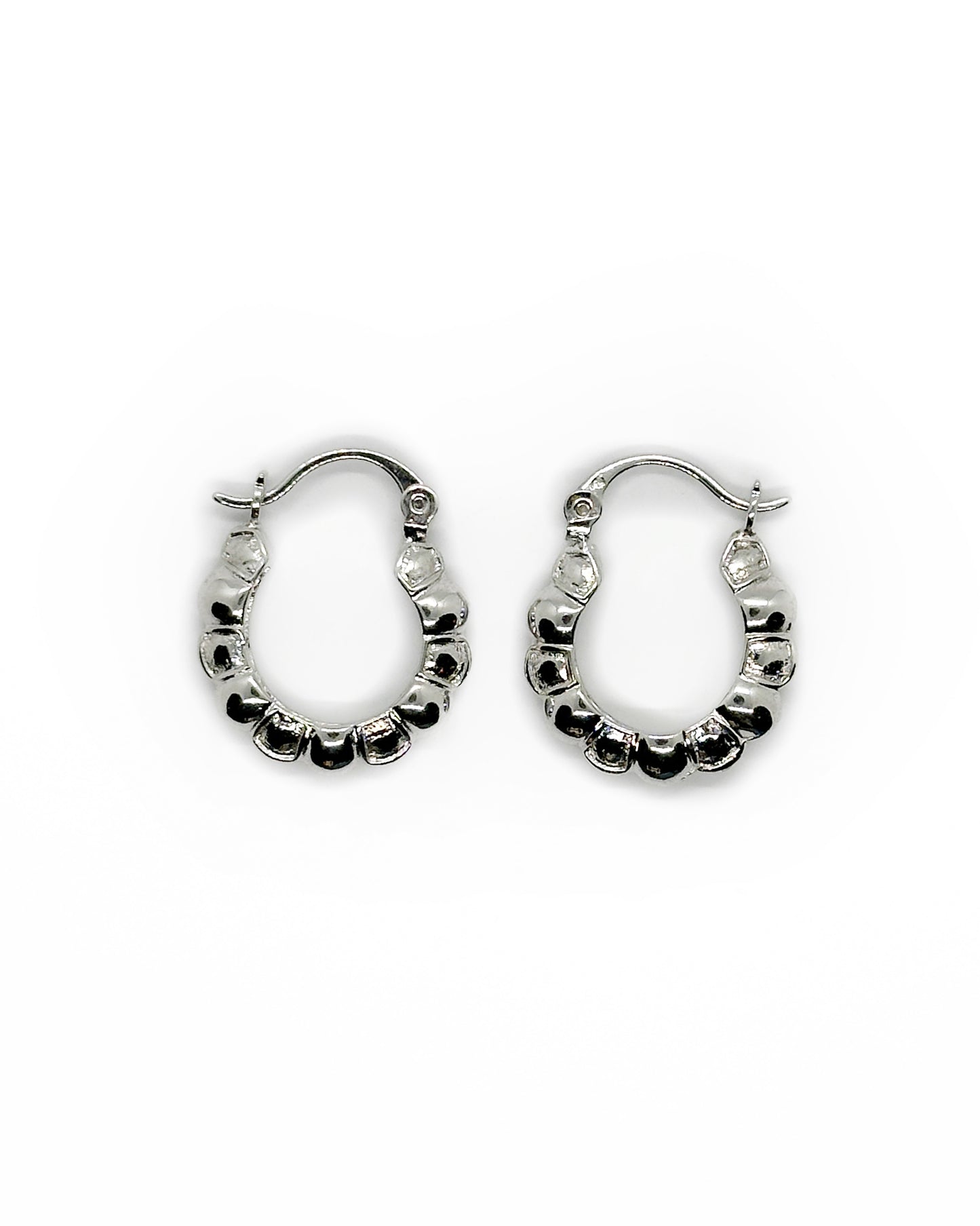 Pair of silver hoop earrings on a white background