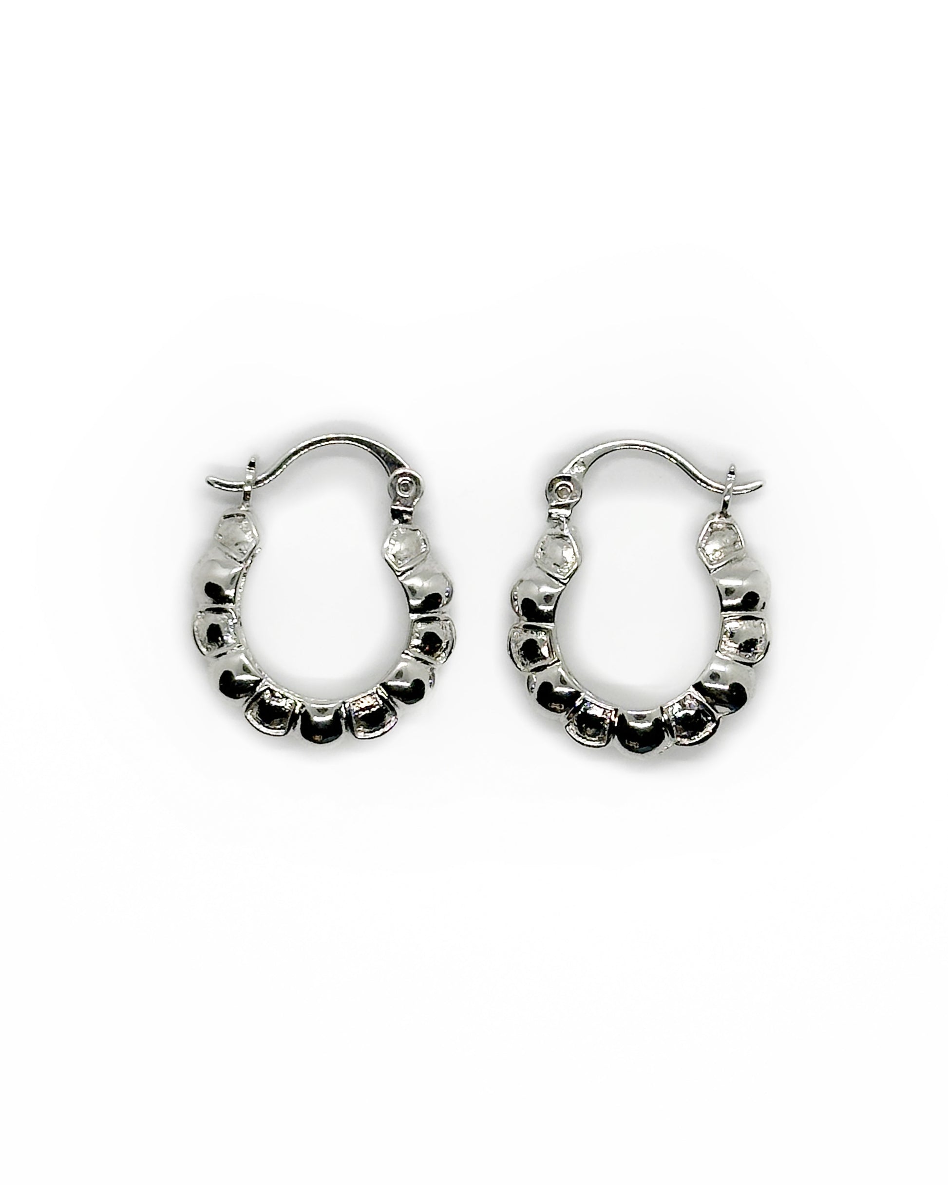 Pair of silver hoop earrings on a white background
