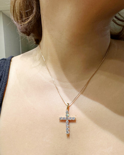 Zirconia cross pendant necklace worn on model, 18-inch chain