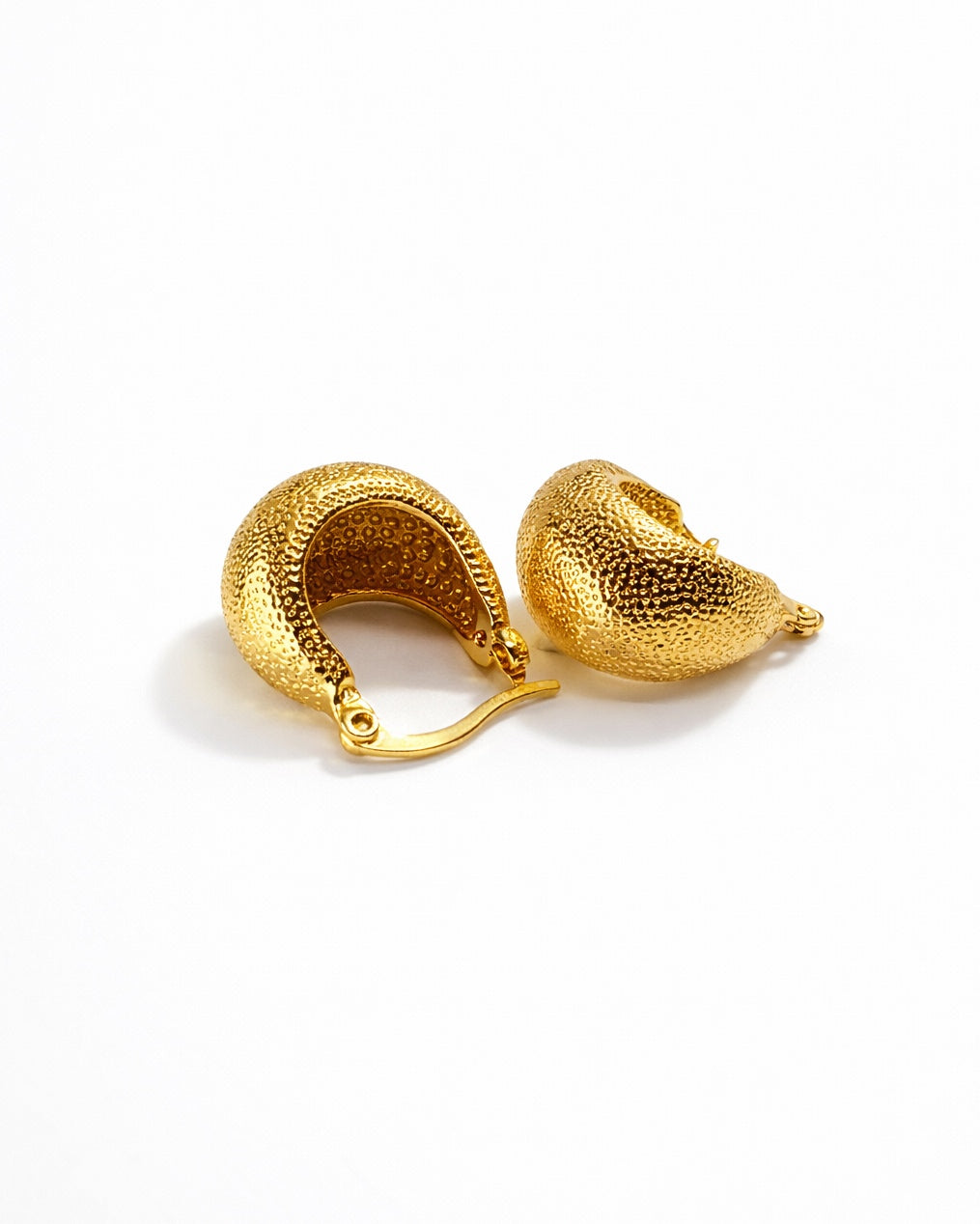 Close-up of the gold texture on the poodle huggie earrings, highlighting the premium craftsmanship.