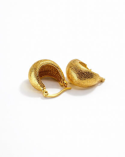 Close-up of the gold texture on the poodle huggie earrings, highlighting the premium craftsmanship.