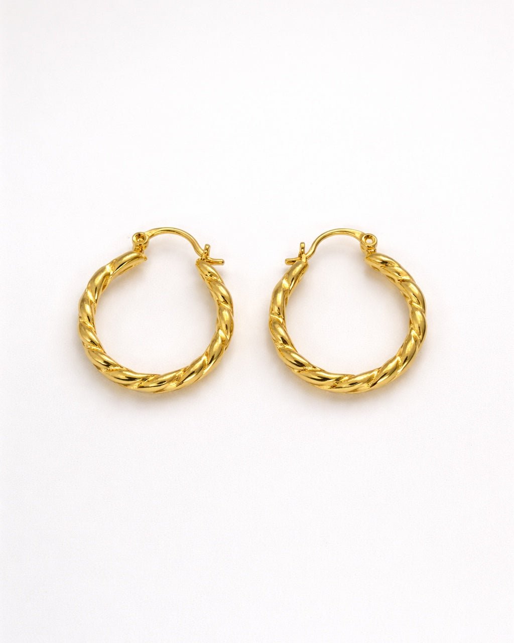 Pair of gold hoop earrings on a white background