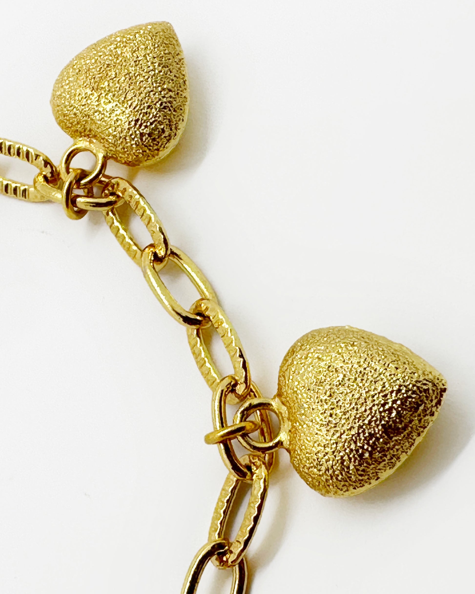 Oval link chain detail with frosted heart charm