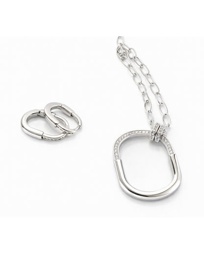 Full jewelry set with oval pendant necklace and huggie earrings clean flat lay