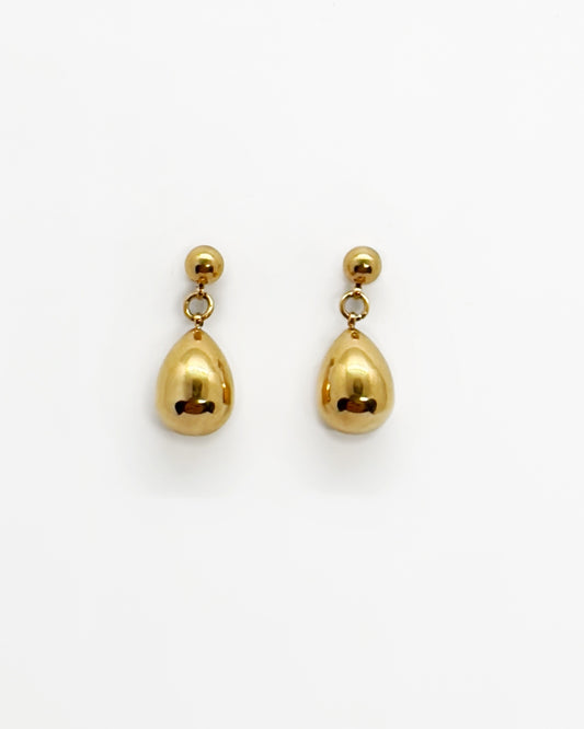 Gold teardrop earrings on a white background