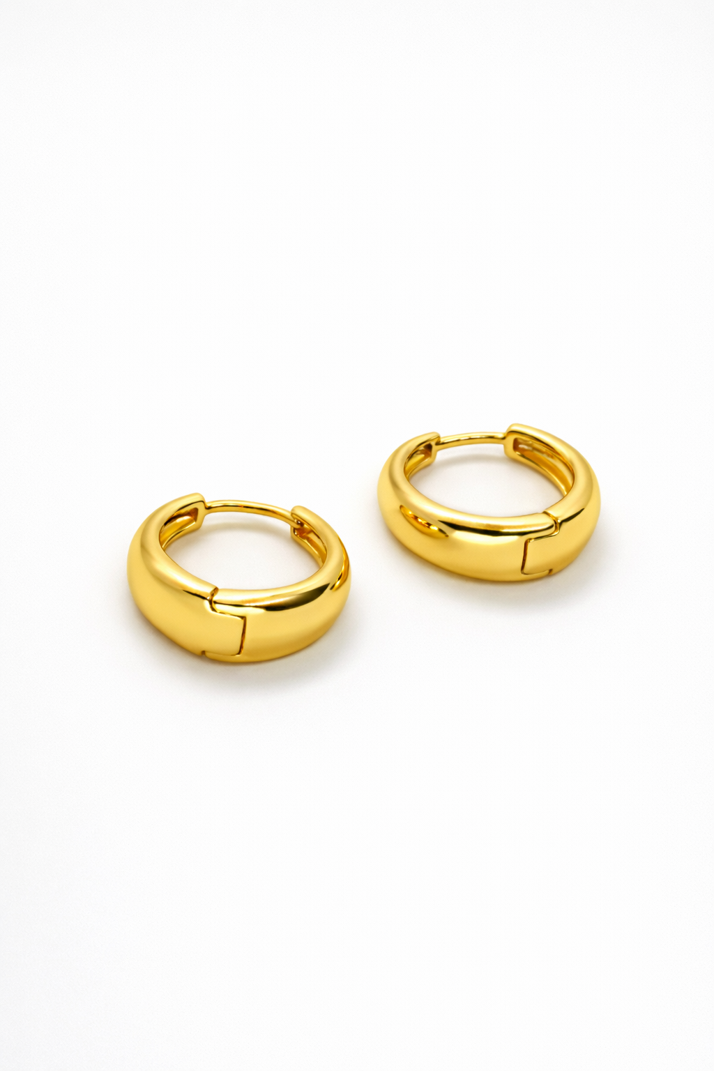 The Cashew Huggie Hoop Earrings in Gold Tone