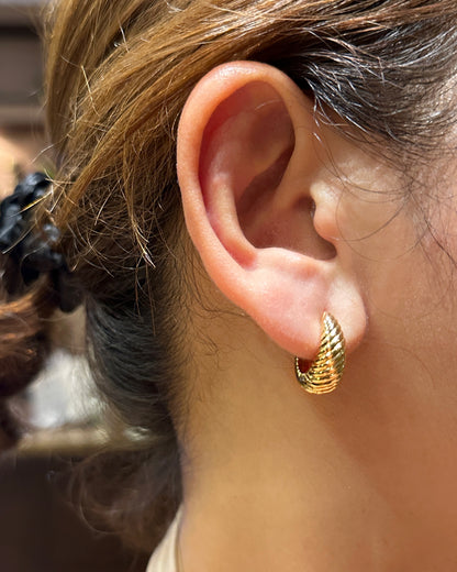 18K gold tone twisted shell hoop earrings worn on ear for everyday elegant look