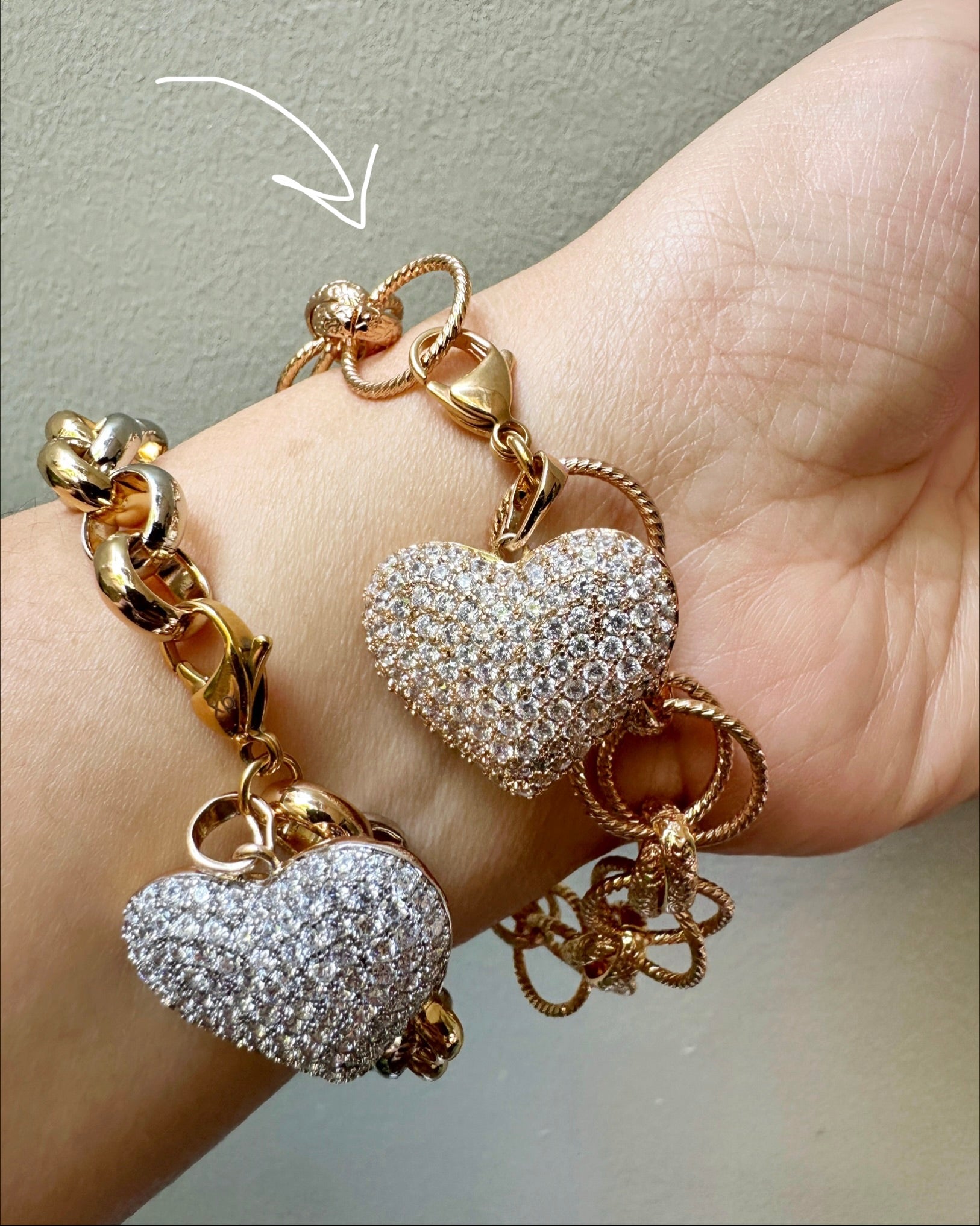 Model wearing the Vintage Heart Link Charm Bracelet on her wrist.