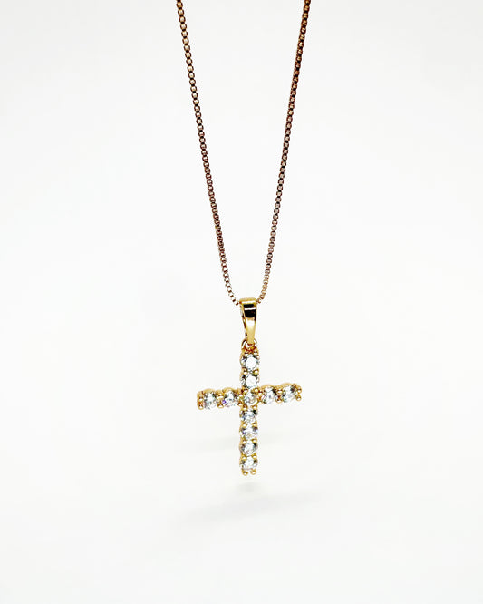 Gold zirconia cross pendant necklace on white background