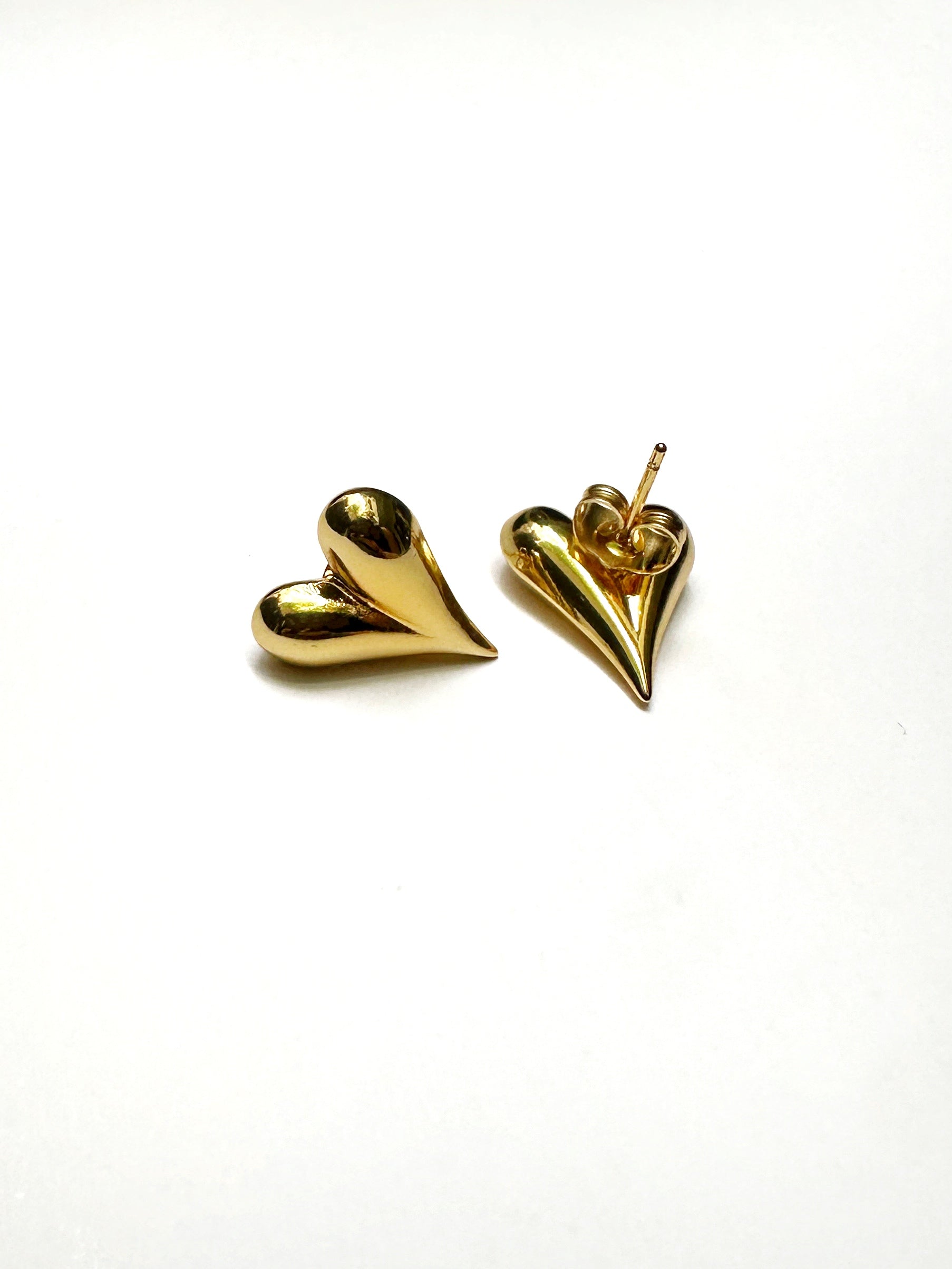 Close-up showing back post of gold stainless heart earrings