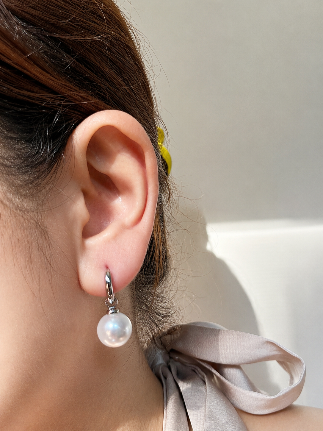 The Perla Sfera Drop Hoops in White Gold Tone