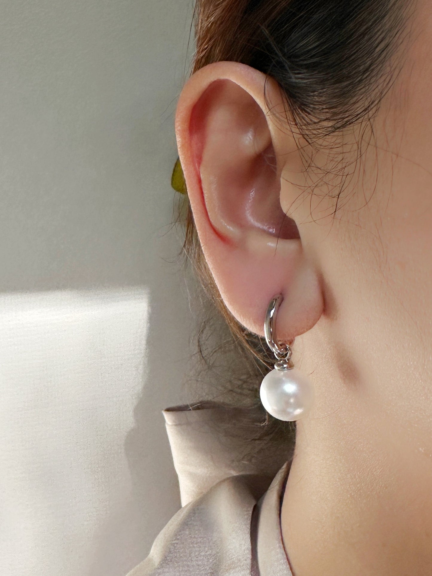 The Perla Sfera Drop Hoops in White Gold Tone