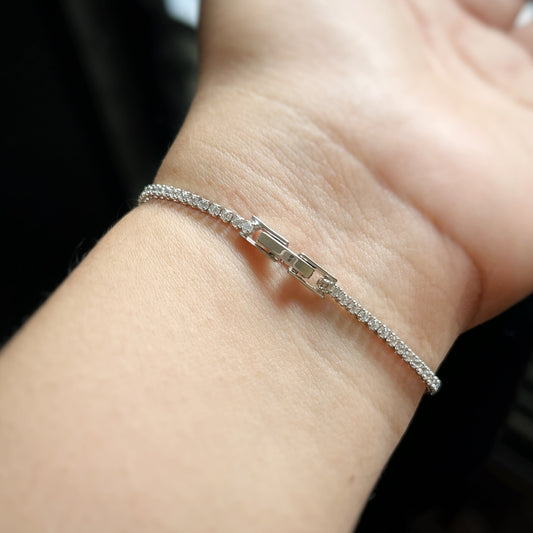 hand wearing whitegold silver petite tennis bracelet showing lock